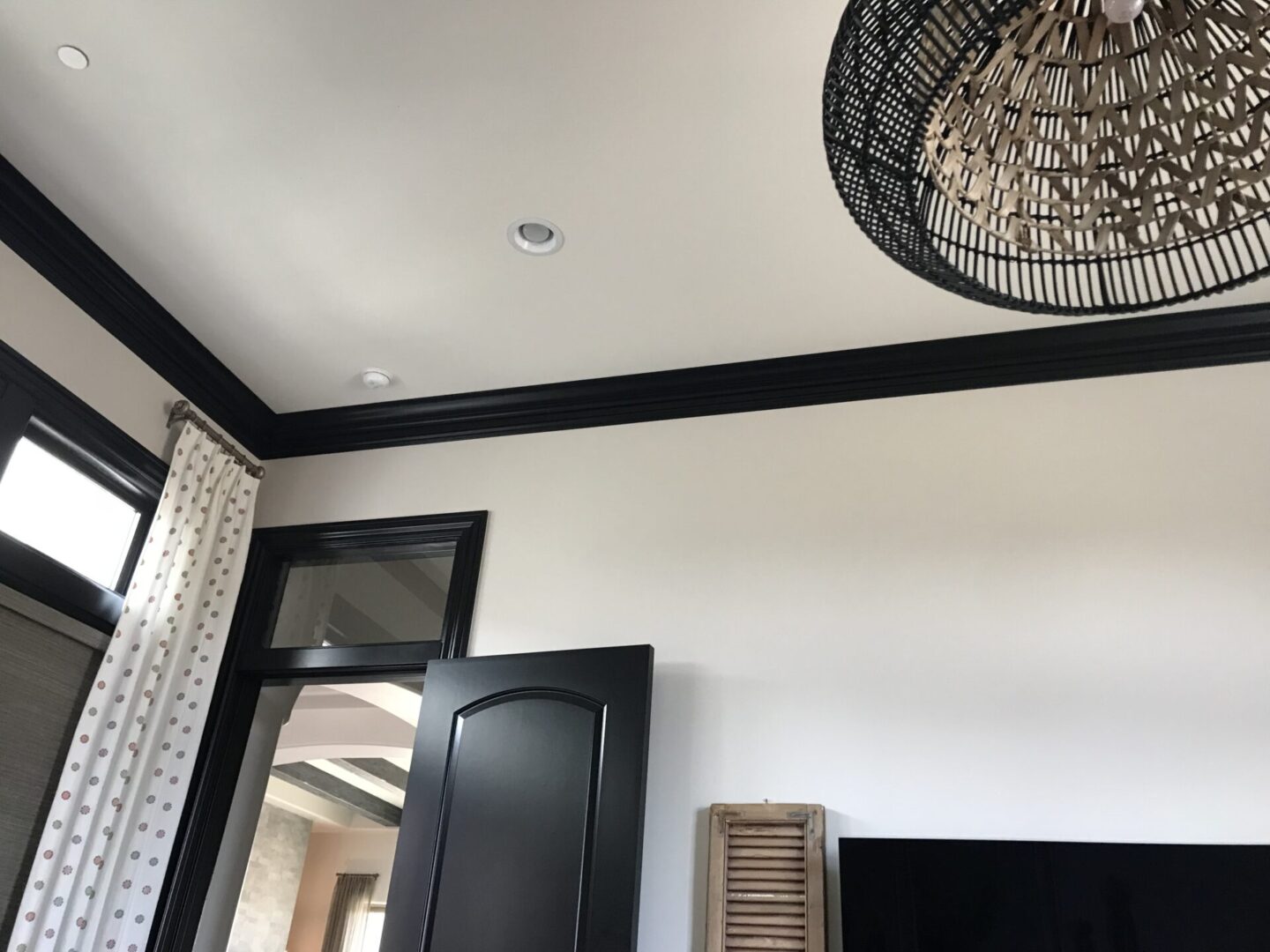 A black door and ceiling in a room.