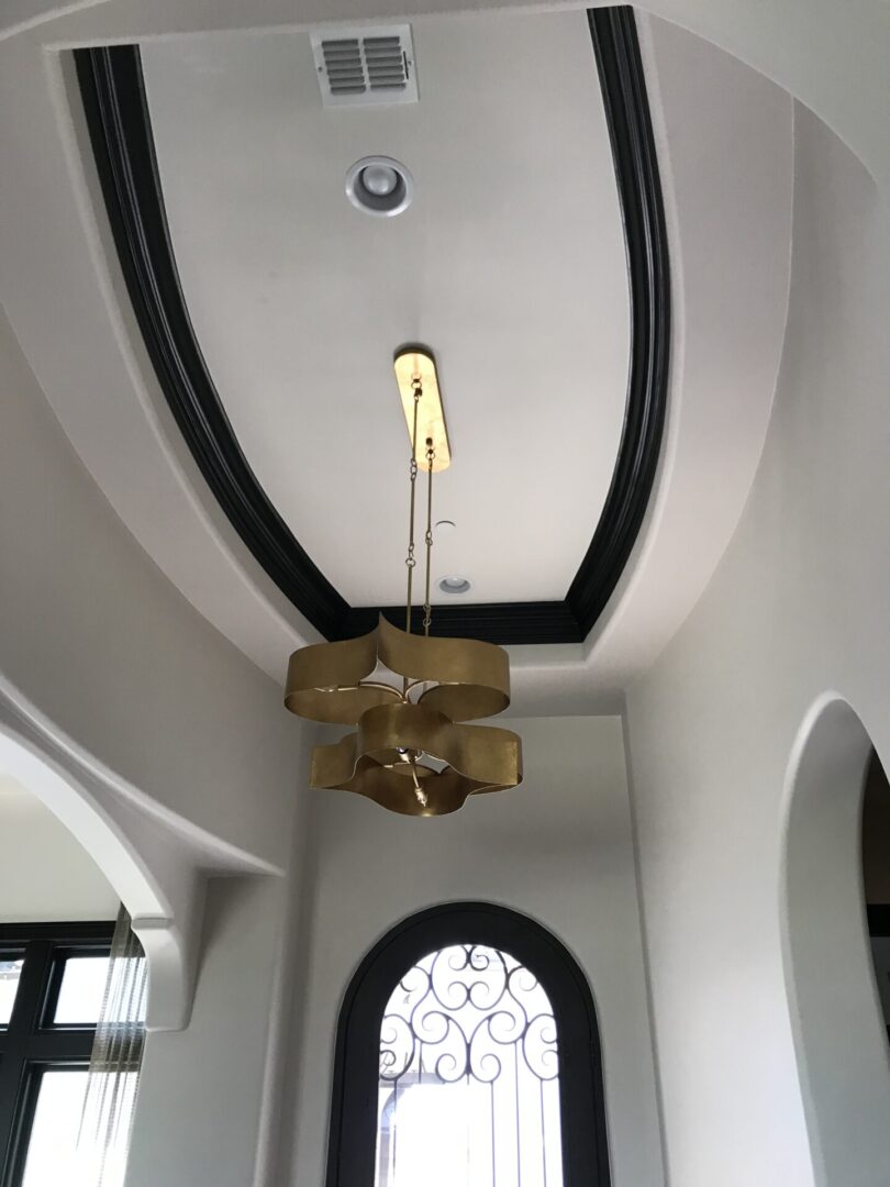 A ceiling with a chandelier and a window