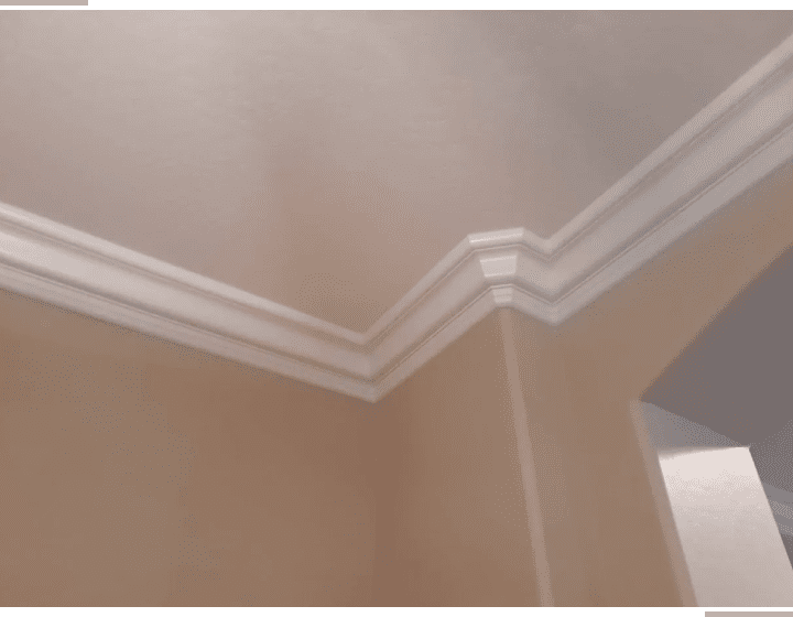 A room with a ceiling and wall that has been painted.