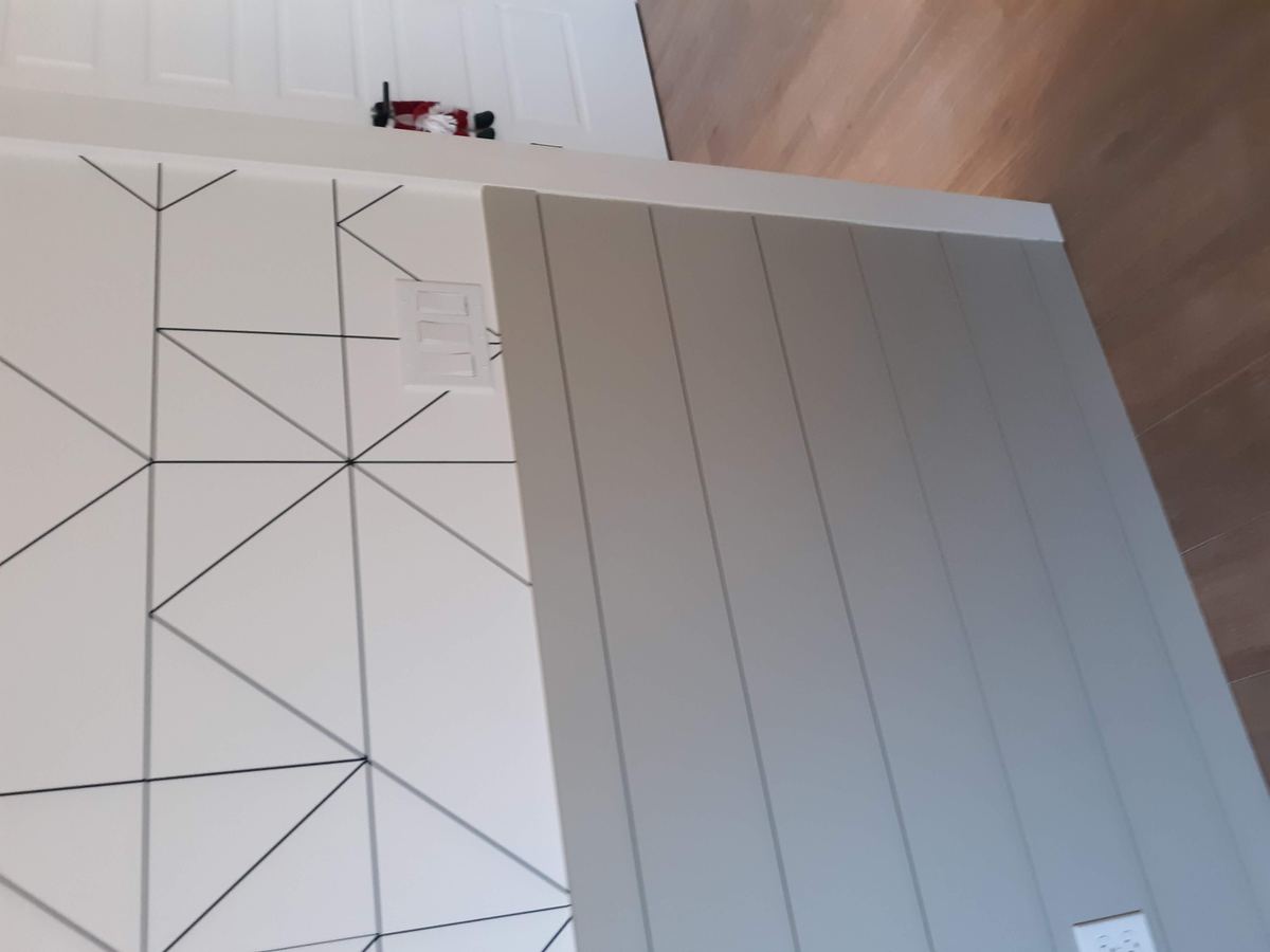 Custom shiplap accent wall with decorative geometric wall detail