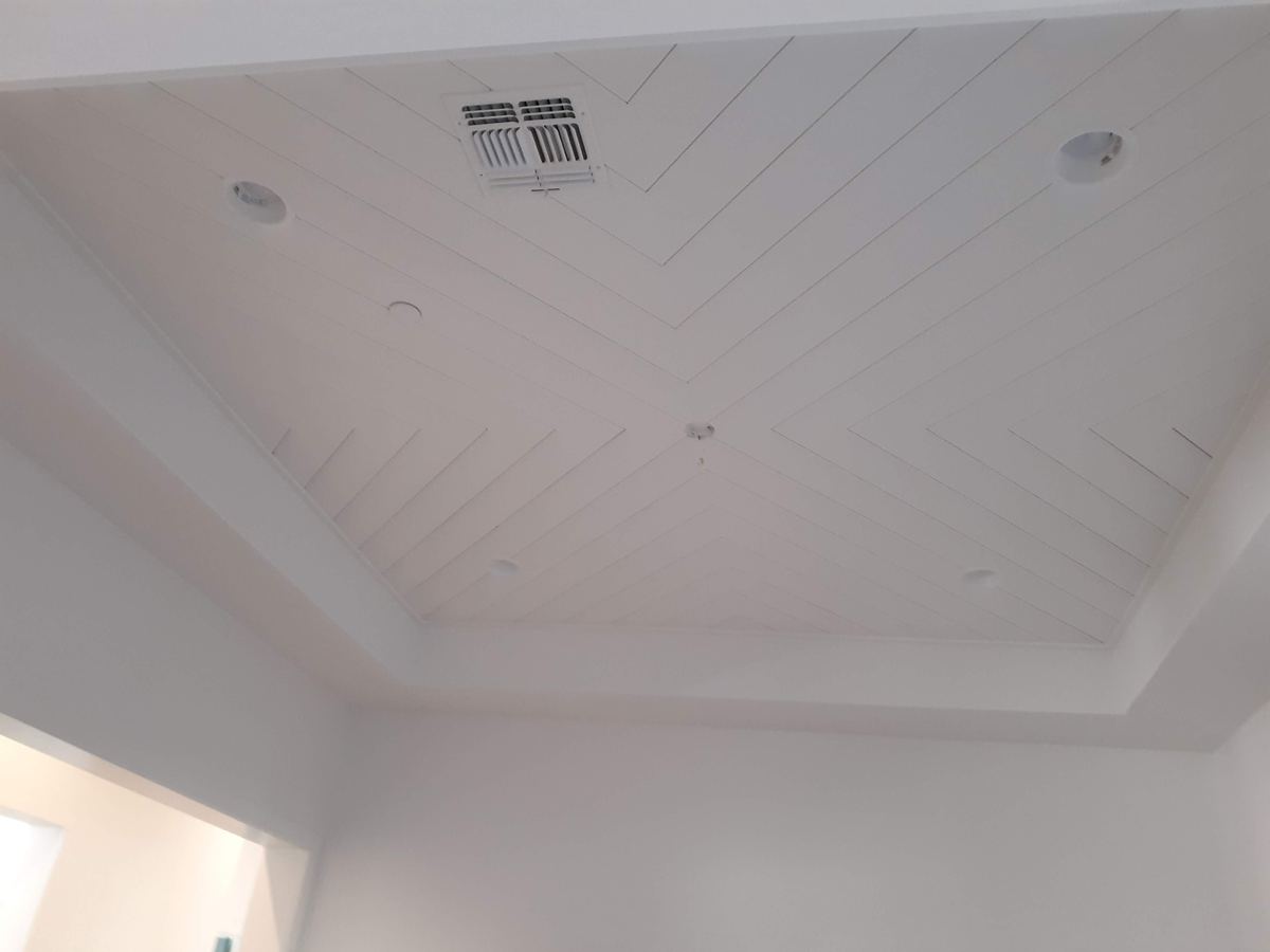 Custom white shiplap ceiling treatment by Heritage Crown and Millworks